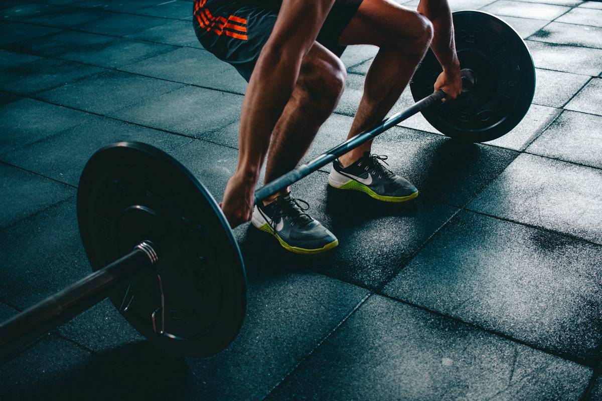 Personal trainer traint met barbell
